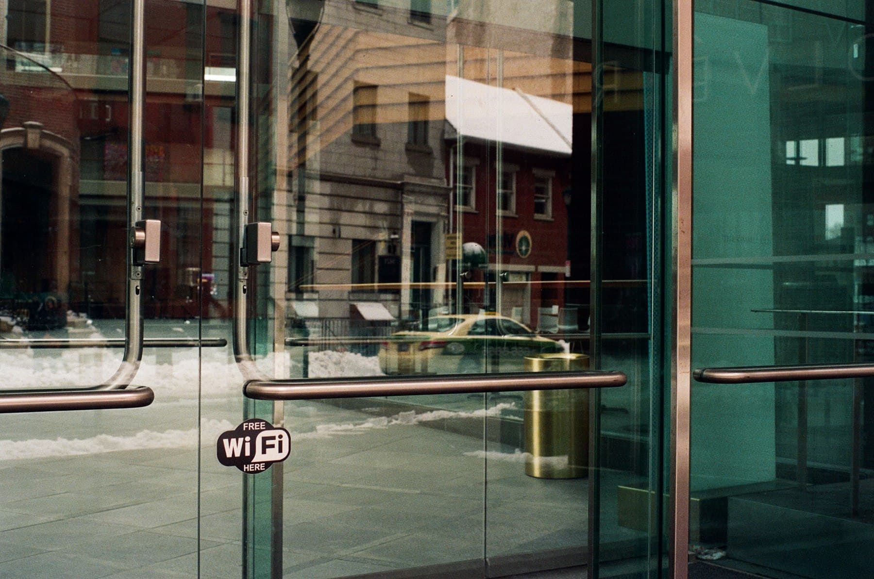 Commercial glass storefront doors with metal pull handles and lock hardware